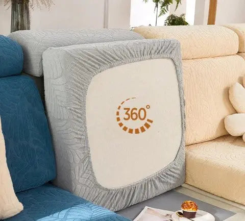 Fundas de sof?­ el?­sticas y texturizadas en tonos azules y grises, dise?ñadas para proteger y renovar el mobiliario con estilo, visibles en un ambiente acogedor de sala de estar - blueemoonco.com